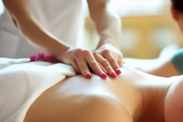 woman getting massage by woman, blurred background